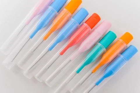 Small colored brushes for cleaning braces on teeth Stock Photos