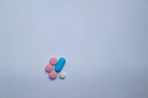 Small colored pills on a neutral background. Free space to write. 스톡 사진