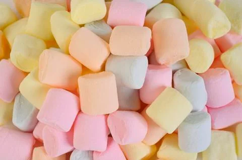 Small colored puffy marshmallows background Stock Photos