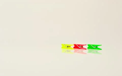 Small colored tweezers on plain background Stock Photos