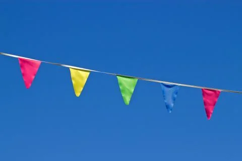 Small colorful flags and a blue sky. Fotos Stock