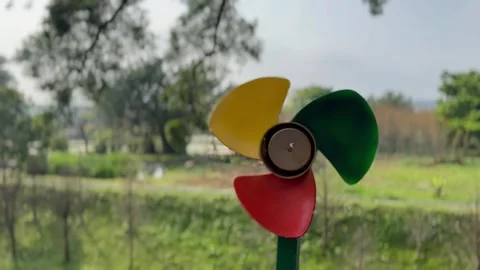 Small colorful windmill spining on a windy day Stock Footage 268994296