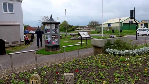 Small Community Garden with Information Pillar on High Street Stock Footage 274446036