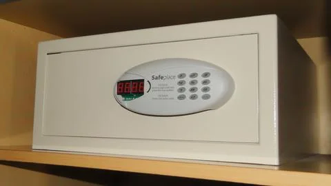 Small compact reliable hotel safe built into the closet for storing valuables Stock Photos