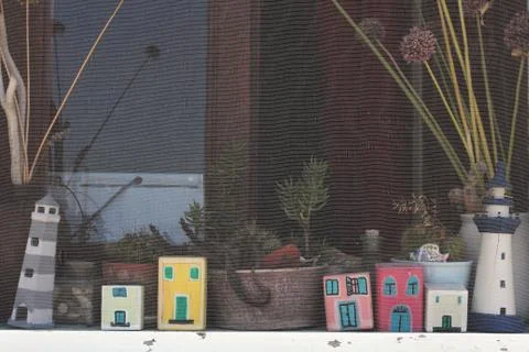 Small composition of sea cottages in the window Stock Photos