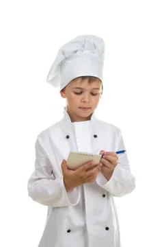 Small concentrated chef writes down a recipe or a menu. White background. Stock Photos