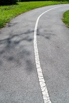 Small concrete path in the middle of meadow Stock Photos