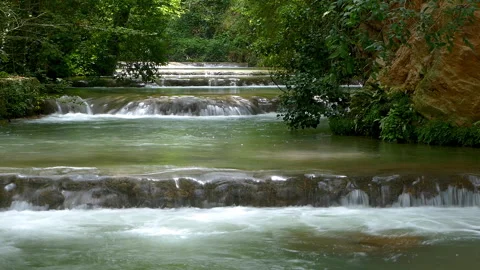Small consecutive waterfalls that flow in an idyllic place. Silk effect. Video stock 287486367