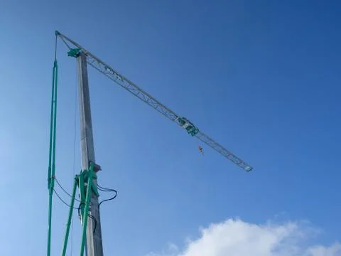 Small construction tower crane ,blue sky in background Stock Photos