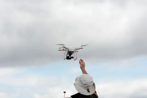 Small consumer drone launch by hand Stock Photos