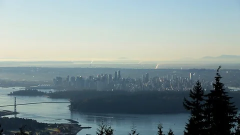 A small consumer drone overlooking a city then flying away evasively. - HD 24 Video stock 119097747