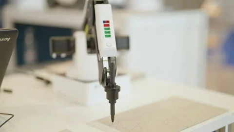 Small consumer robot arm drawing on paper 4K Stock Footage 235936074