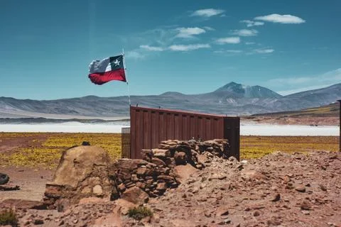 Small container with the Chilean flag waving thanks to the great desert breeze Stock Photos
