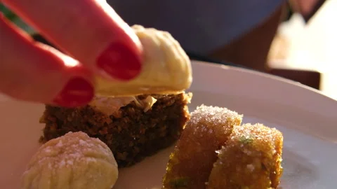 Small cookie in hand. Turkish Layered Sweets Stock Footage 316248080