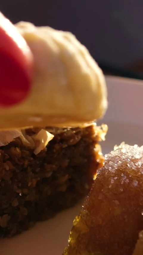Small cookie in hand. Turkish Layered Sweets Stock Footage 317697407
