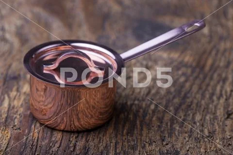 Small copper pot on wood Stock Photos