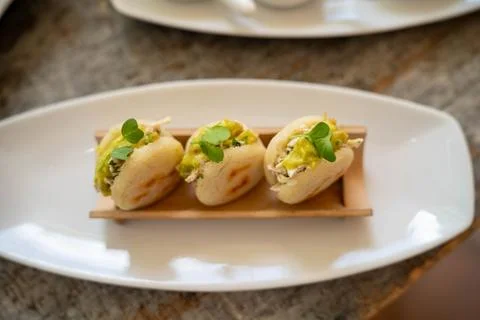 Small corn cake arepas filled with chicken avocado guacamole and topped wit.. Stock Photos