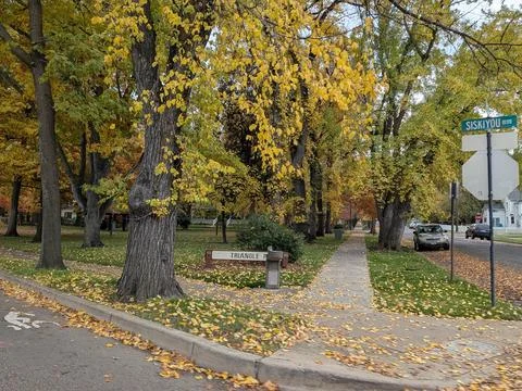 A small corner park named “Triangle Park” features a drinking fountain Stock Photos
