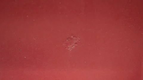 Small corrosion spot on a red car paint close up. Stock Footage 341485360