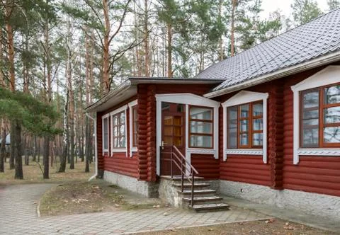 A small cottage in a forested area. Stock Photos