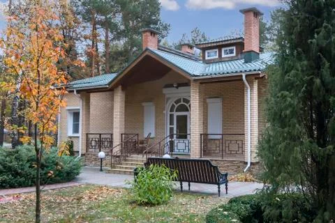 A small cottage in a forested area. Stock Photos