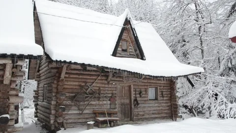 Small cottage in mountains during winter. Cabin in the snowy woods. Snow Stock-Footage 147348491