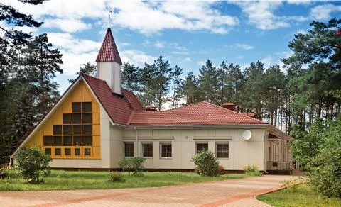 A small cottage of original architectural planning in a forest Park. Stock Photos