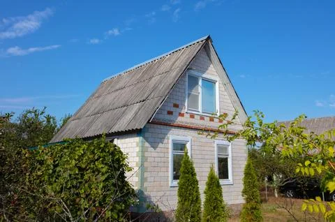 Small country house with a plot. Typical houses given in the post-Soviet spac Stock Photos