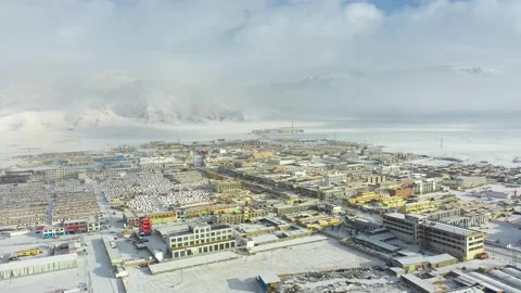 A small county city surrounded by snow Stock Footage 243025832