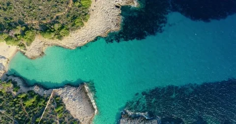 Small cove in Menorca. The water is transparent and turquoise next to a forest o Stock-Footage 147635563