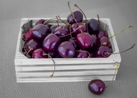 Small crate with cherries. Stock Photos