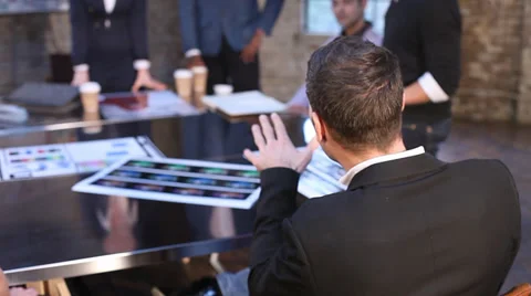 Small creative team gathering discussing a project in shabby chic business Stock-Footage 32728514