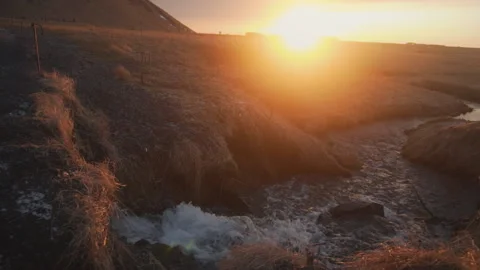 A small creek close to the waterfall in the winter of Iceland at sunset Stock Footage 106242504