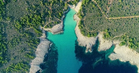 Small creek in Menorca. The water is transparent and turquoise next to a forest Stock Footage 147635554