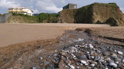 Small creek with water going down on the beach Stock Footage 131837395