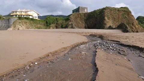 Small creek with water going down on the beach Stock Footage 131837488