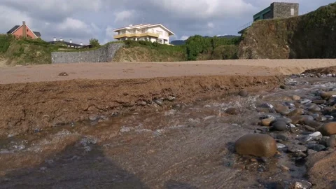 Small creek with water going down on the beach Stock Footage 131837636
