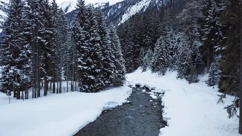 Small Creek In Winter Snowy Forest Among Snow Banks Aerial Stock Footage 104116244