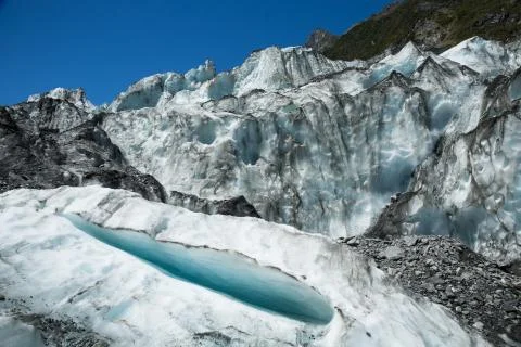Small crevasse below seracs of an icefall on the Fox Glacier in New Zealand Stock Photos