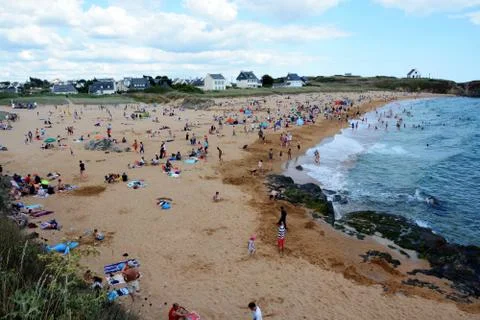 Small crowded beach by the ocean Stock Photos