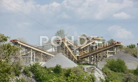 Small crusher plant is operating at wild nature place. Stock Photos