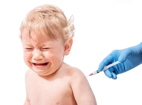 A small crying child got an injection in the his shoulder. Stock Photos