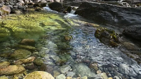A small crystal clear river cascades with a small waterfall  Stock Footage 142707156