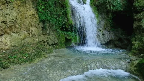 Small crystal clear waterfall stream taman mudal waterfall yogyakarta Stock Footage 137078331
