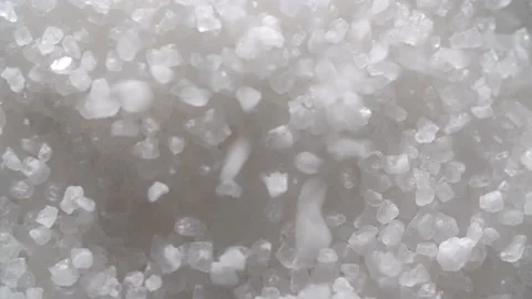 Small crystals of sea salt fall from top to bottom on the surface of sea salt Stock Footage 179535386