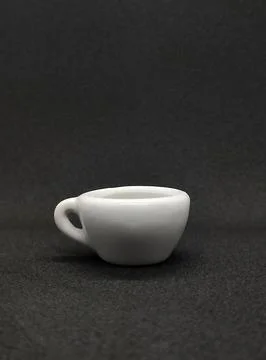 A small cup on a black background Stock Photos