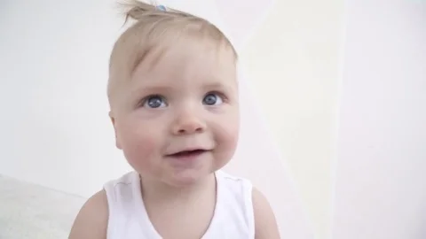 Small cute baby boy looking at the camera and playing with it Stock Footage 73629248