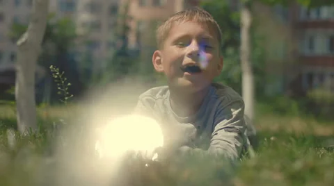 Small, cute boy 6 years makes sunbeams Stock Footage 37692598