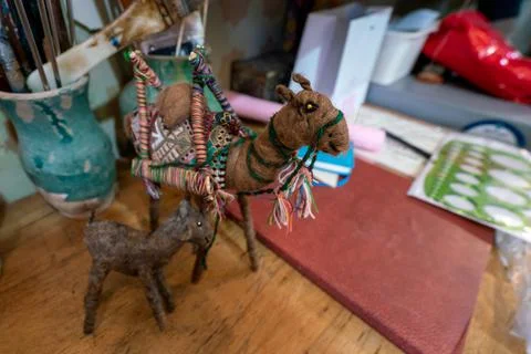 A small, cute camel puppet on a table in artist's shop. Art of Kerman, Iran. Stock Photos