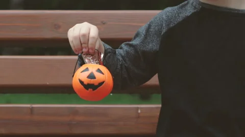 Small cute halloween pumpkin bucket in kid little boy hand Stock Footage 211726064
